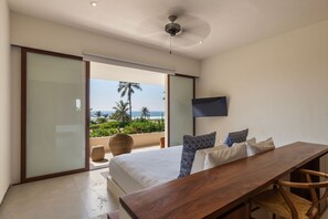Wake up to the sight of waves crashing from this spacious bedroom featuring a private terrace and elegant furnishings.