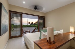Wake up to breathtaking ocean views in this serene bedroom, featuring a cozy bed, private balcony, and natural light-filled ambiance.