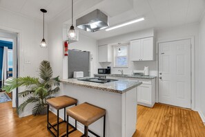 Cook up a feast in this sleek, fully-equipped kitchen featuring stainless steel appliances and granite countertops—perfect for whipping up local favorites!