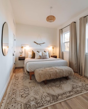 The king bedroom is cozy and inviting - and offers a smart tv in both the bedroom and living room.