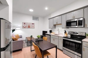 Modern kitchen with sleek stainless-steel appliances and ample counter space.