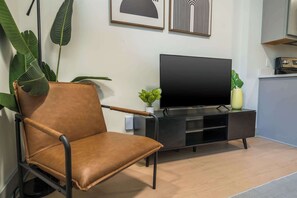 Living Room: Unwind with a good book or simply relax in this cozy corner with ample natural light.