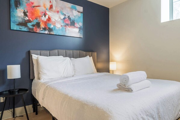 A thoughtfully designed bedroom with minimalist decor, perfect for a restful night.