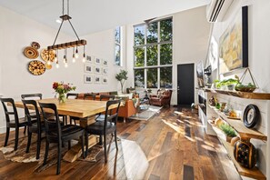 This space features plush seating, a large Smart TV, and a dining table for eight.