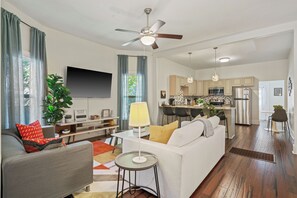 Colorful and bright open-concept living room that connects to the kitchen 
