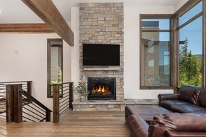 Gas fireplace in the living room with a large Smart TV offering both cable and streaming options.