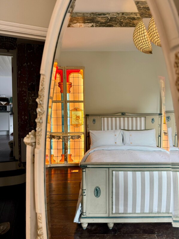 Master bedroom with French Louis XVI Kingsize luxury bed and balcony.
