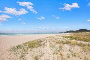 The golden sands of Palm Beach are right across the road from this breezy beachfront stay.