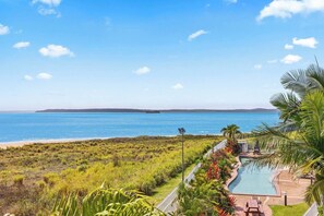 Take a dip in the communal pool or relax poolside with views of the ocean and marina.
