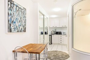 The dining area leads into the modern kitchenette and bathroom, perfect for enjoying a cosy coffee break.
