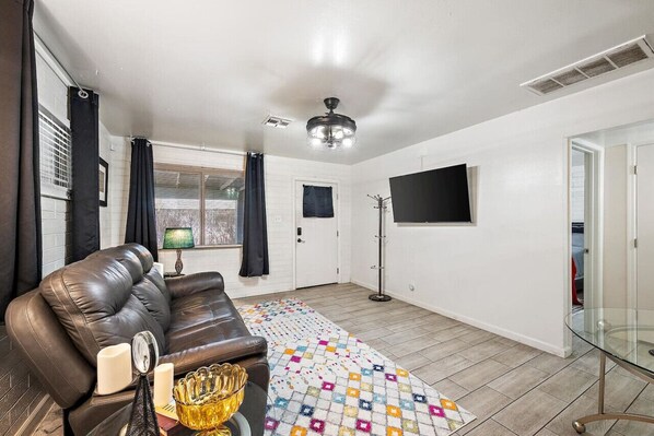 Relax and unwind in the cozy living room, perfect for movie nights or catching up on work.