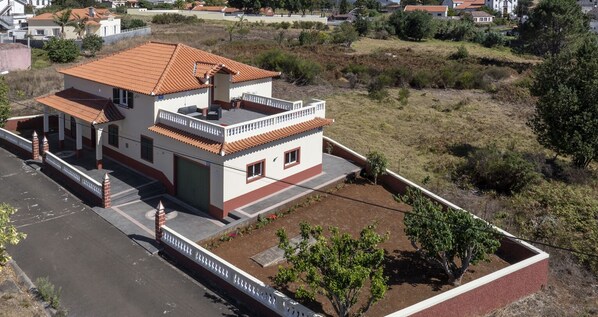 An Exterior View Of Prazeres Paradise Apartment By Ourmadeira Showing The Surrounding Countryside And Distance To The Church