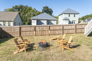 Fenced backyard with outdoor furniture and fire pit