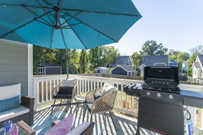 Balcony with bbq grill and outdoor furniture