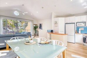 Bright and open living / dining opening out to deck. 