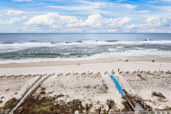 A breathtaking view from the 8th-floor balcony of the condo, overlooking the pristine white sandy beach and the sparkling turquoise waters of the Gulf of Mexico.       