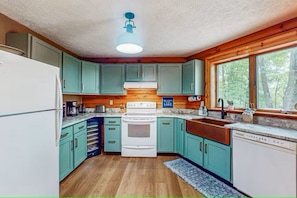 Kitchen has a wine chiller and a hand hammered copper farmhouse sink.