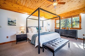 The primary bedroom features a king size canopy bed with an Aireloom mattress.