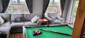 Large bright sun room with snooker table and second T.V.