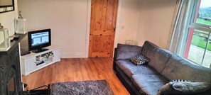 Cosy sitting room with solid fuel stove and T.V.
