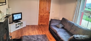 Cosy sitting room with solid fuel stove and T.V.