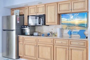 Loaded Kitchen with Smart TV Microwave, stovetop burners, full-sized refrigerator, and air fryer