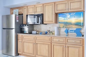 Loaded Kitchen with Smart TV Microwave, stovetop burners, full-sized refrigerator, and air fryer