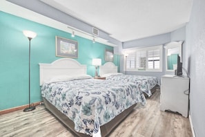 Relax on these comfy and cozy queen beds after a long vacation day. This room has plenty of storage options, and a Smart TV to stream all you favorite apps. Rest Easy and wake up refreshed in this oceanfront themed escape.