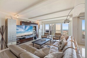 A cozy entertainment area equipped with a large TV and comfortable sofas, perfect for movie nights or a relaxing evening indoors.