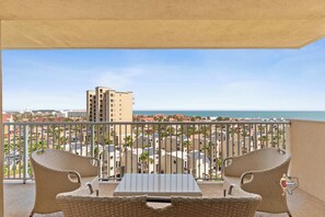 Unwind on the private balcony with seating, offering breathtaking views of the surrounding landscape and skyline.