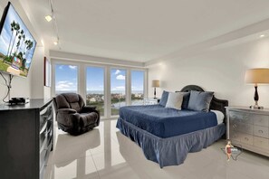 Bedroom 1 - Wake up to serene sea views from this beautifully furnished king bedroom, complete with a plush bed and entertainment setup.
