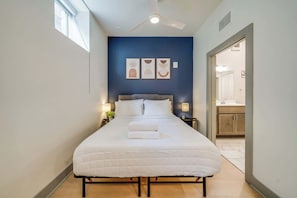 Stylish Queen bed that enhances the comfort and charm of the studio unit.