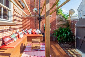 Outdoor Oasis: Vibrant seating, playful decor, and sunlight await your perfect relaxation spot!