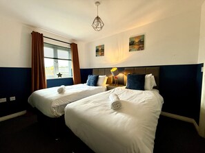 Twin Room: Bright and inviting with modern decor, perfect for relaxing adventures in Gloucestershire!