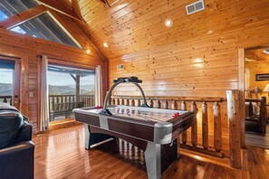 Game room with seating, TV, pool table, air hockey, & arcade