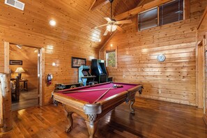 Game room with seating, TV, pool table, air hockey, & arcade