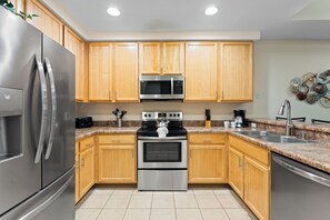The cozy kitchen offers ample space & all the comforts of home