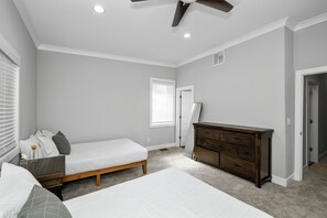 The 3rd bedroom offers a pair of queen beds, private en suite, & ceiling fan