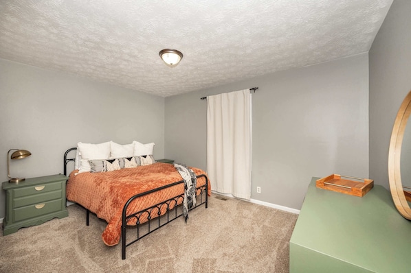 This upper-level bedroom includes a queen bed & ample storage