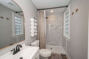 Apt 1 – The full bathroom offers a walk-in shower & chic finishes