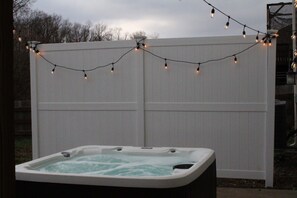 Soak under the stars in a private hot tub oasis ✨🛁 Surrounded by string lights and a cozy privacy fence, it’s the perfect place to unwind and relax!