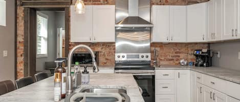 The chic, updated kitchen offers ample space & every home comfort