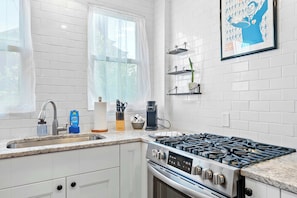 The bright, updated kitchen offers ample space & all the comforts of home