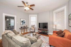 Cozy and spacious living area with TV