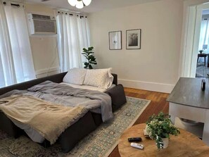 The tranquil living room offers a Smart TV & cozy queen sleeper sofa