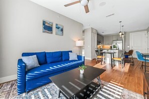 The living room is filled with natural light, creating a bright and welcoming space that invites relaxation.