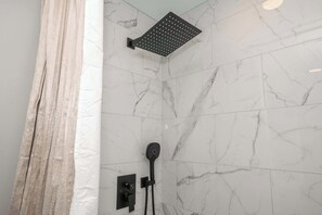 The full bathroom offers a walk-in shower & chic finishes