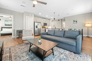The living room is filled with natural light, creating a bright and welcoming space that invites relaxation.