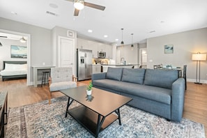 The living room is filled with natural light, creating a bright and welcoming space that invites relaxation.