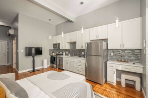 Relax with your favorite streaming in this chic studio’s plush queen-sized bed